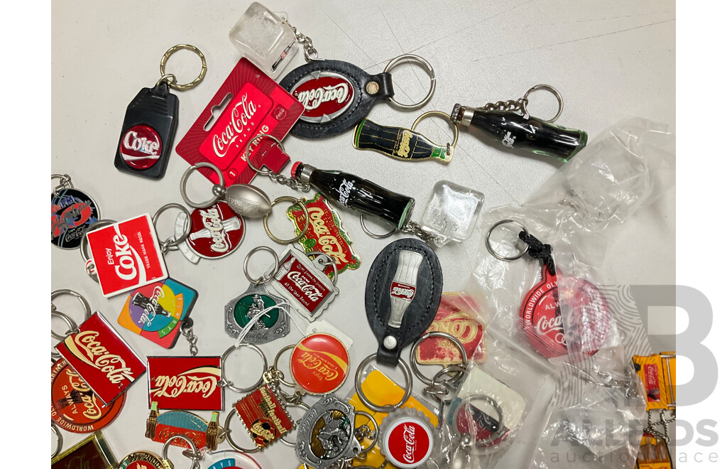 Collection of Coca Cola Keyrings Including NASCAR and Olympics