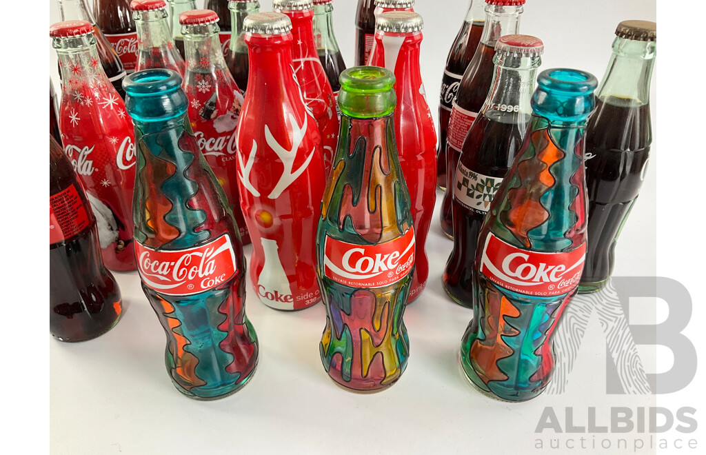 Collection of Coca Cola Glass Bottles Including Christmas and Stained Glass Examples