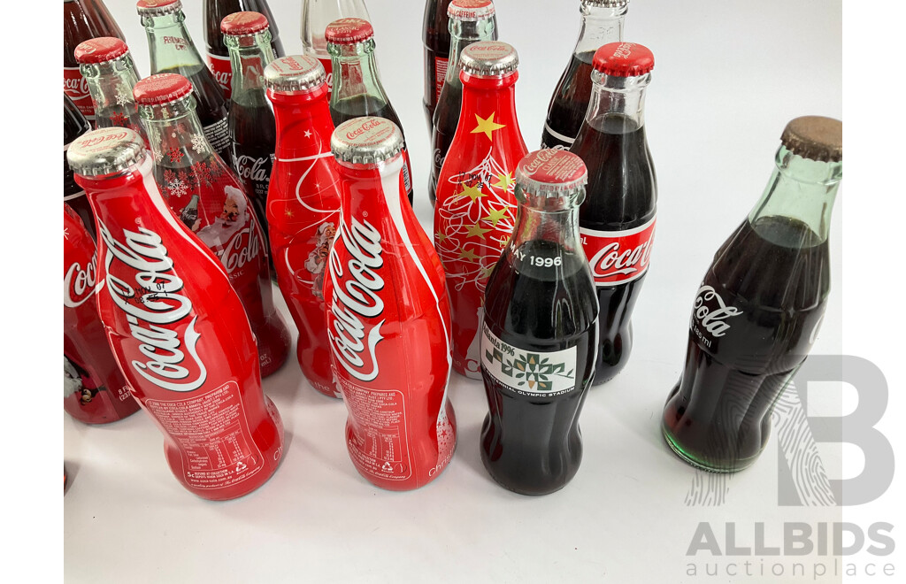 Collection of Coca Cola Glass Bottles Including Christmas and Stained Glass Examples