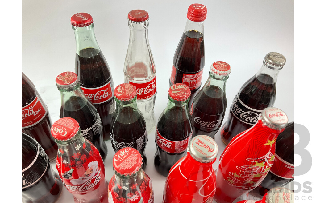 Collection of Coca Cola Glass Bottles Including Christmas and Stained Glass Examples