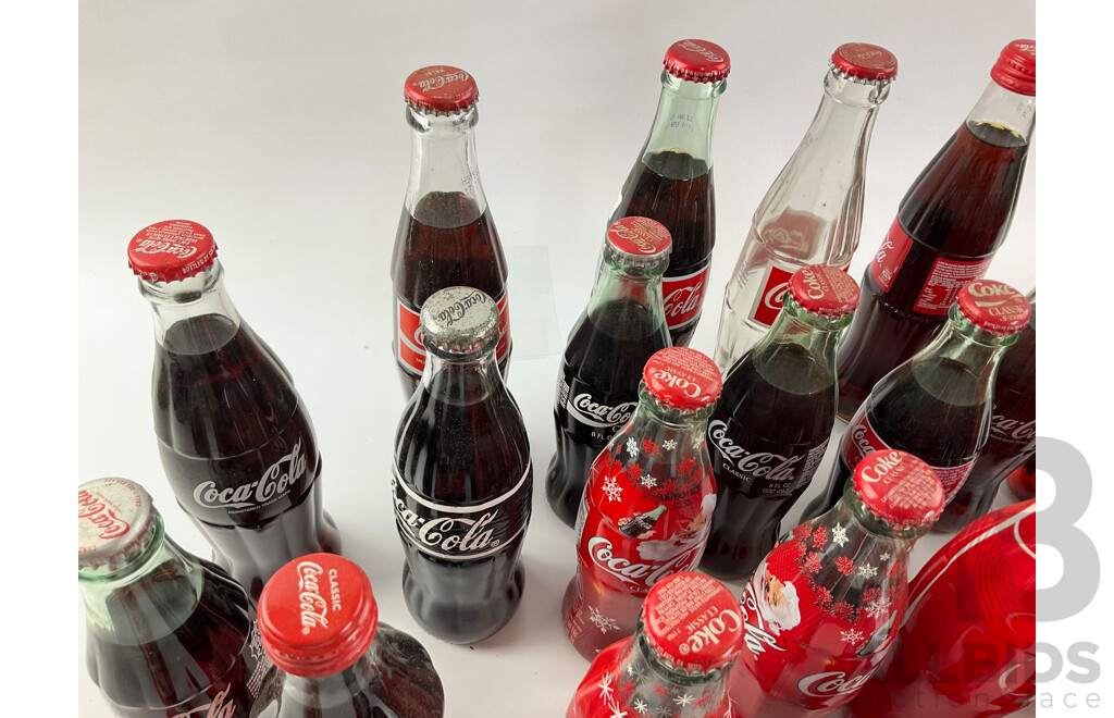 Collection of Coca Cola Glass Bottles Including Christmas and Stained Glass Examples