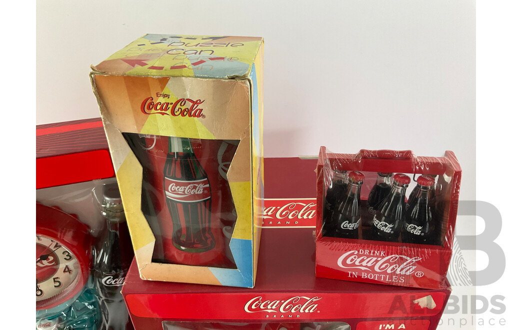 Assortment of Coca Cola Items Including Moulded Wall Clock, Bank Alarm Clock, Diecast Vehicles, Tins, Cups, Collector and Cooking Books