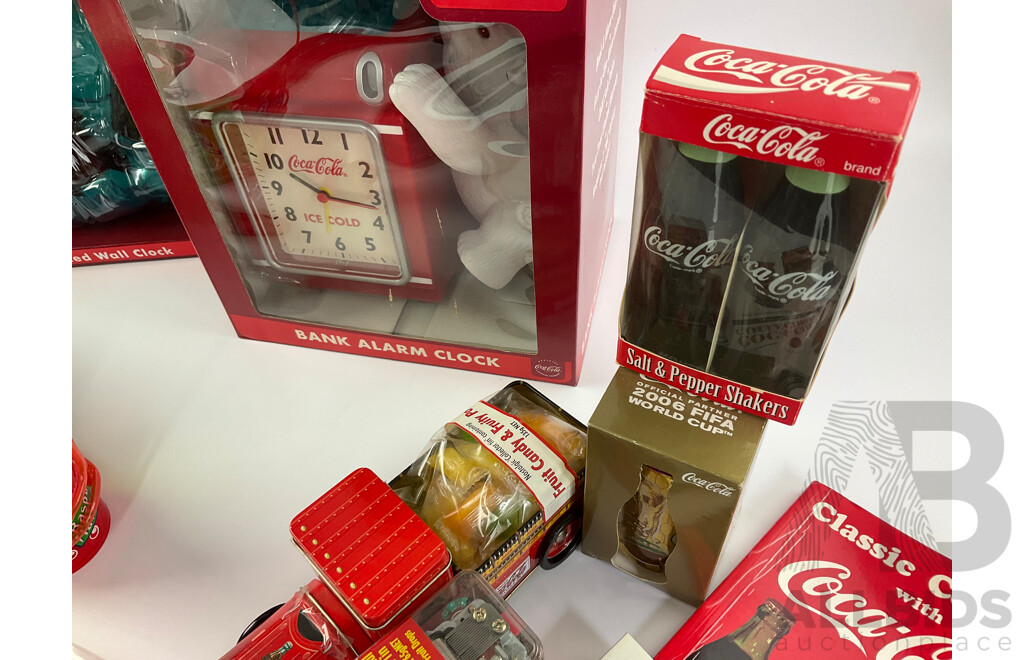 Assortment of Coca Cola Items Including Moulded Wall Clock, Bank Alarm Clock, Diecast Vehicles, Tins, Cups, Collector and Cooking Books