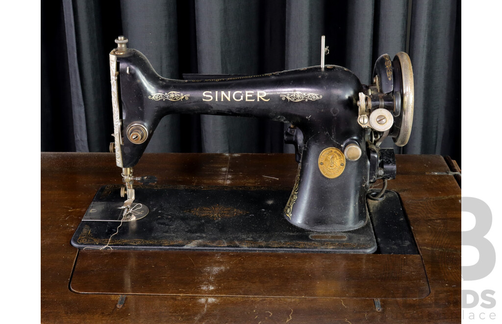 Antique Singer Sewing Machine in Elevated Cabienrt