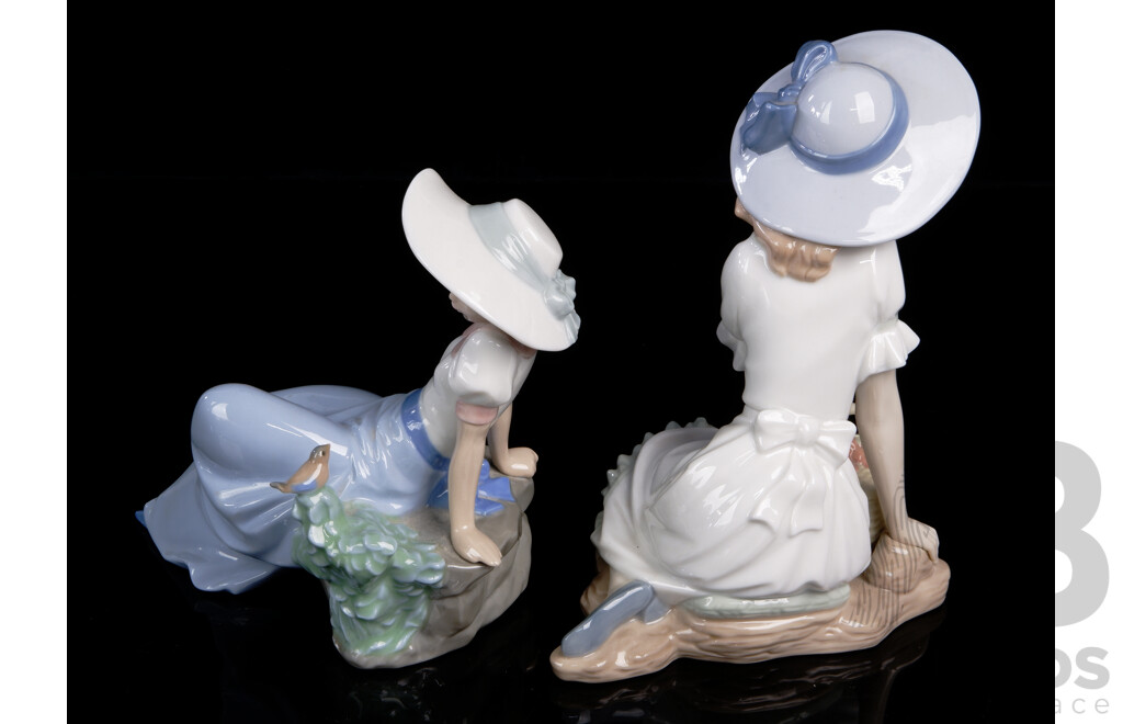 Two Hand Made & Decorated Spanish Nao Porcelain Figures Comprising Reclining Young Maiden with Bird & Seated Girl with Flower Basket