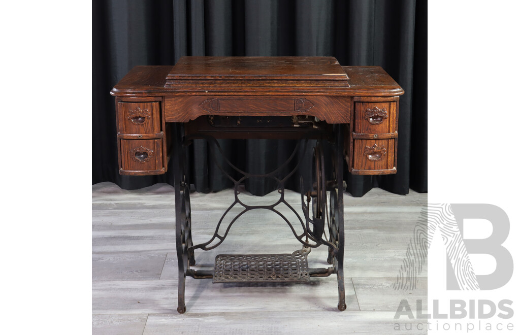 Singer Treadle Base Sewing Machine in Oak Cabinet