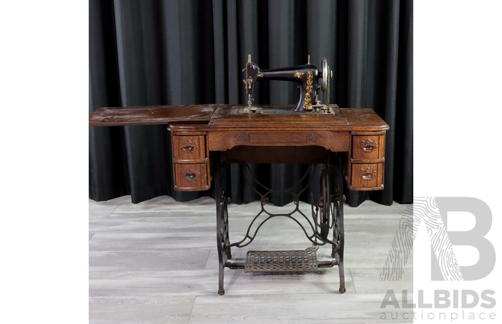 Singer Treadle Base Sewing Machine in Oak Cabinet