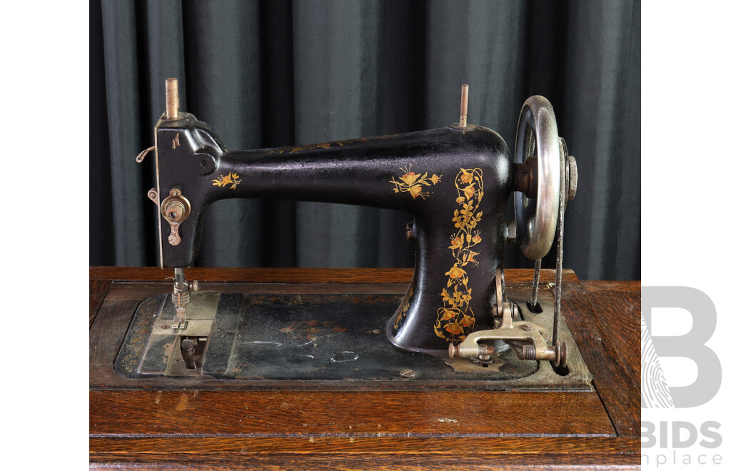 Singer Treadle Base Sewing Machine in Oak Cabinet