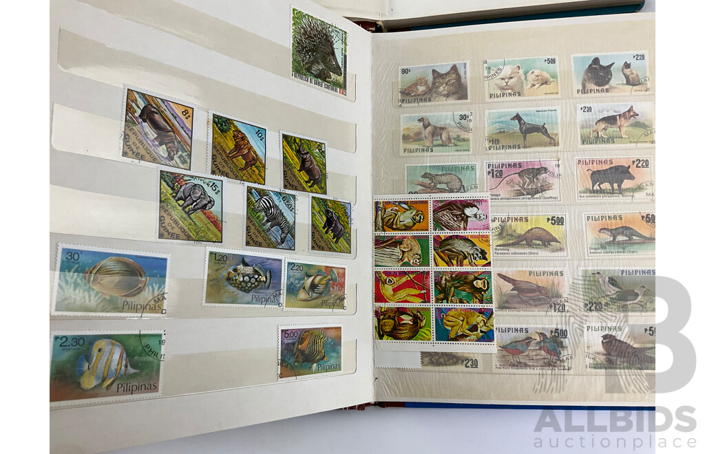 Four Albums of International Mint and Cancelled Stamps Including India, Germany, Rwanda, Australia, Cayman Islands, Magyar, USA, New Zealand, Fiji, Uruguay and More