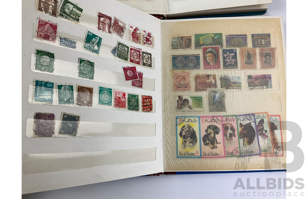 Four Albums of International Mint and Cancelled Stamps Including India, Germany, Rwanda, Australia, Cayman Islands, Magyar, USA, New Zealand, Fiji, Uruguay and More