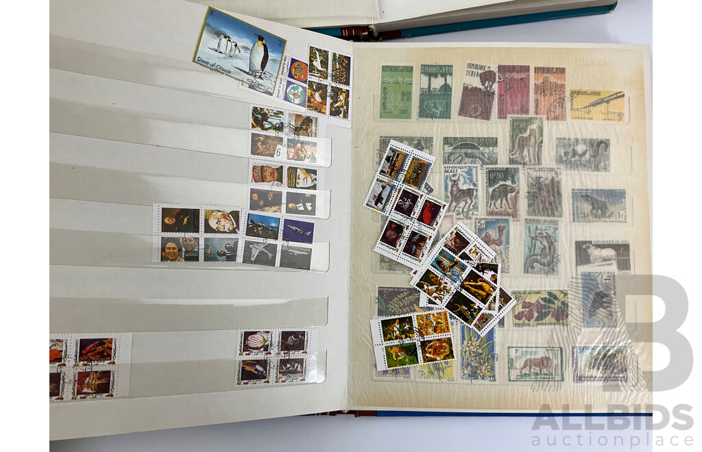 Four Albums of International Mint and Cancelled Stamps Including India, Germany, Rwanda, Australia, Cayman Islands, Magyar, USA, New Zealand, Fiji, Uruguay and More