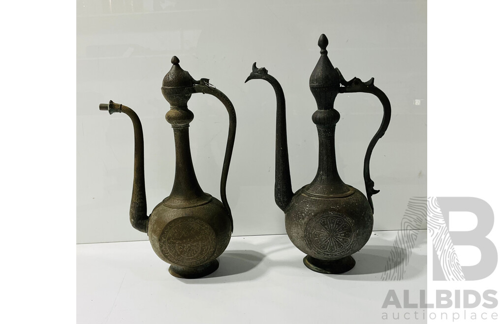 Pair of Middle Eastern Brass Pitchers with Engraved Detail