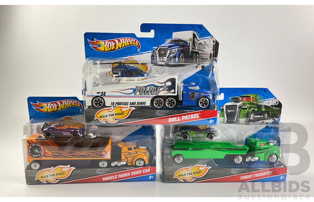 Three Boxed Hot Wheels Trucks Including Muscle Mania Show Car, Police Roll Patrol and Fright Freighter