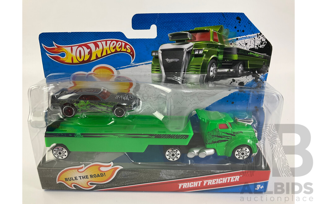 Three Boxed Hot Wheels Trucks Including Muscle Mania Show Car, Police Roll Patrol and Fright Freighter