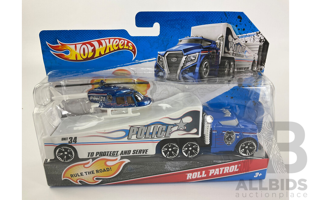 Three Boxed Hot Wheels Trucks Including Muscle Mania Show Car, Police Roll Patrol and Fright Freighter