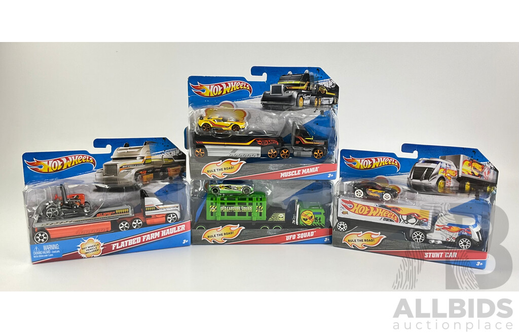 Four Boxed Hot Wheels Trucks Including Flatbed Farm Hauler, Stunt Car, Muscle Mania, UFO Squad