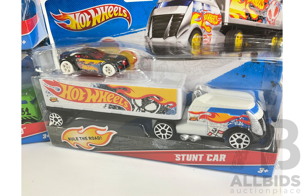 Four Boxed Hot Wheels Trucks Including Flatbed Farm Hauler, Stunt Car, Muscle Mania, UFO Squad