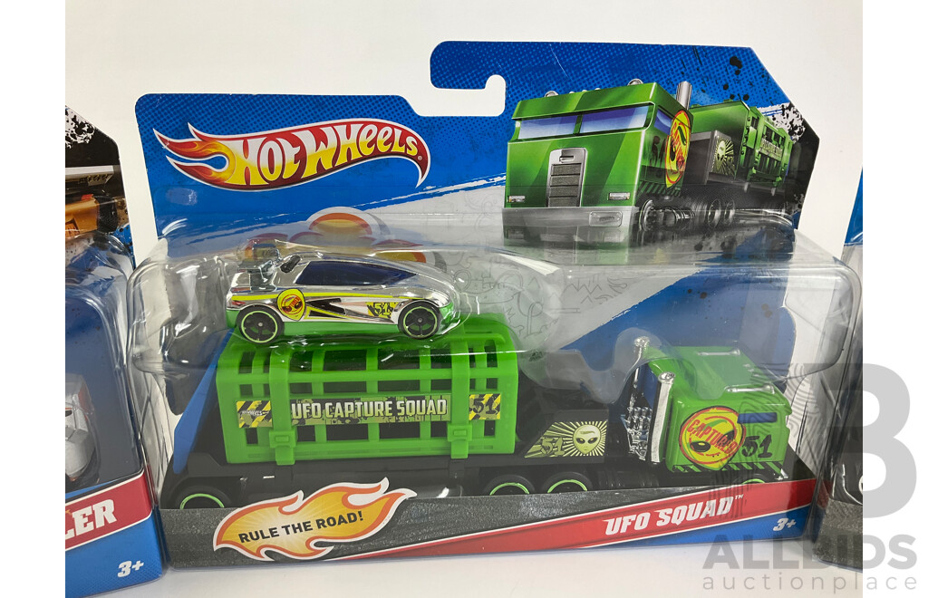 Four Boxed Hot Wheels Trucks Including Flatbed Farm Hauler, Stunt Car, Muscle Mania, UFO Squad