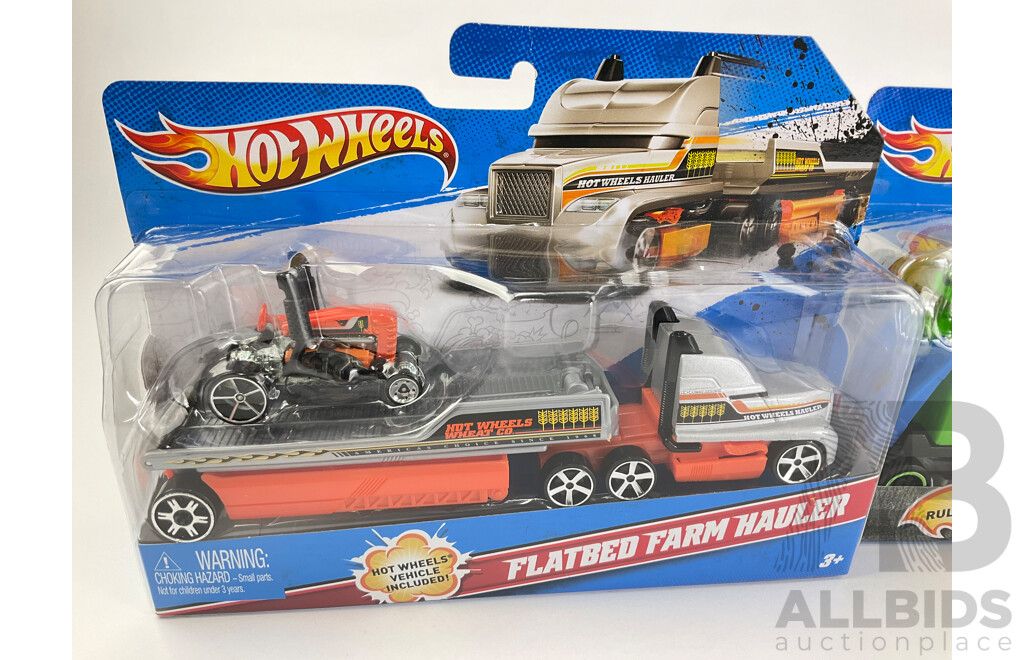 Four Boxed Hot Wheels Trucks Including Flatbed Farm Hauler, Stunt Car, Muscle Mania, UFO Squad