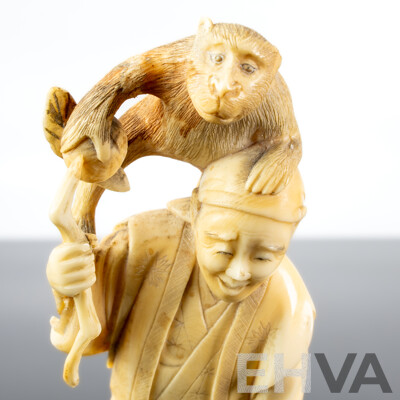 Antique Japanese Hand Carved Ivory Okimono of Man with Sickle and Monkey