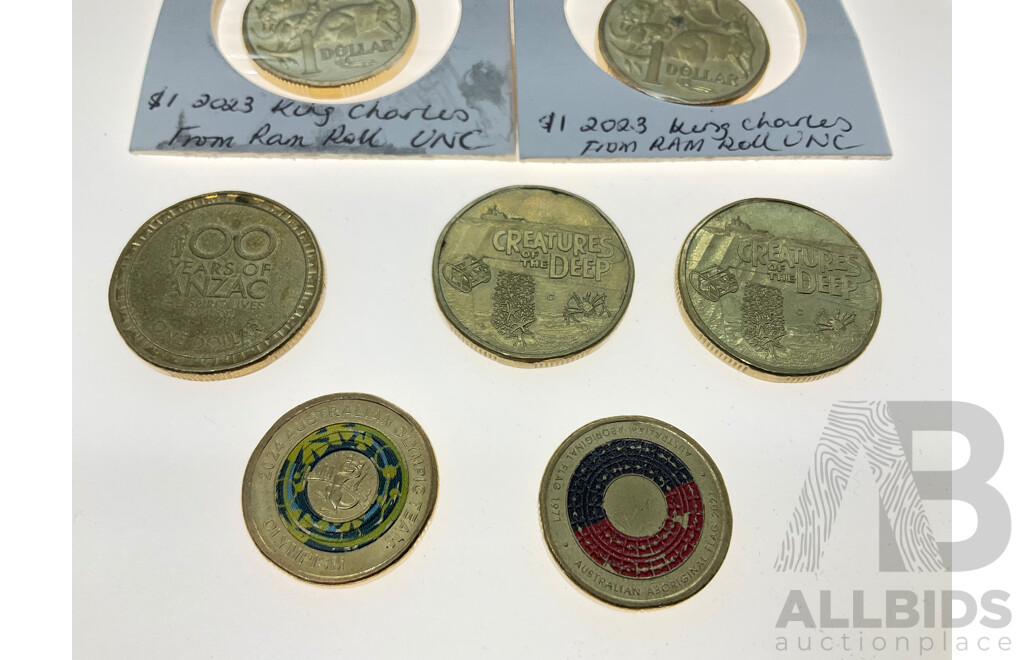 Seven Australian One Dollar Coins Including Four UNC 2023 KCIII, Two 2023 Creatures of the Deep, 2016 100 Years of ANZAC, Two Dollars 2021 Aboriginal Flag, 2024 Olympic Team