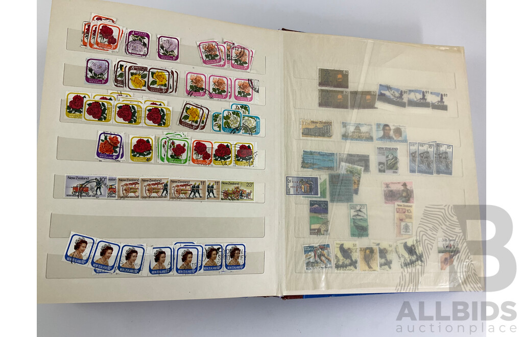 Two Albums of Vintage Stamps Including New Zealand, Dubai, Mongolia, Poland, Cocos Islands, Zimbabwe, Singapore, Canada, Yugoslavia, USA, Netherlands, UK, Fiji, France, PNG, Grenada, Isle of Men