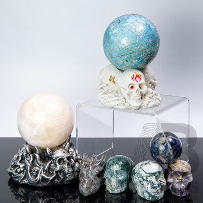 Collection Carved Polished Stone Pieces Including Three Memento Mori Skulls, Two Spheres on Composite Stand and More