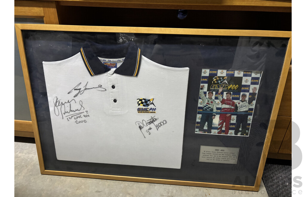 L104 - Framed 2000 GMC 400 polo shirt signed by top three finishers - Steven Richards, Craig Lowndes and Neil Crompton