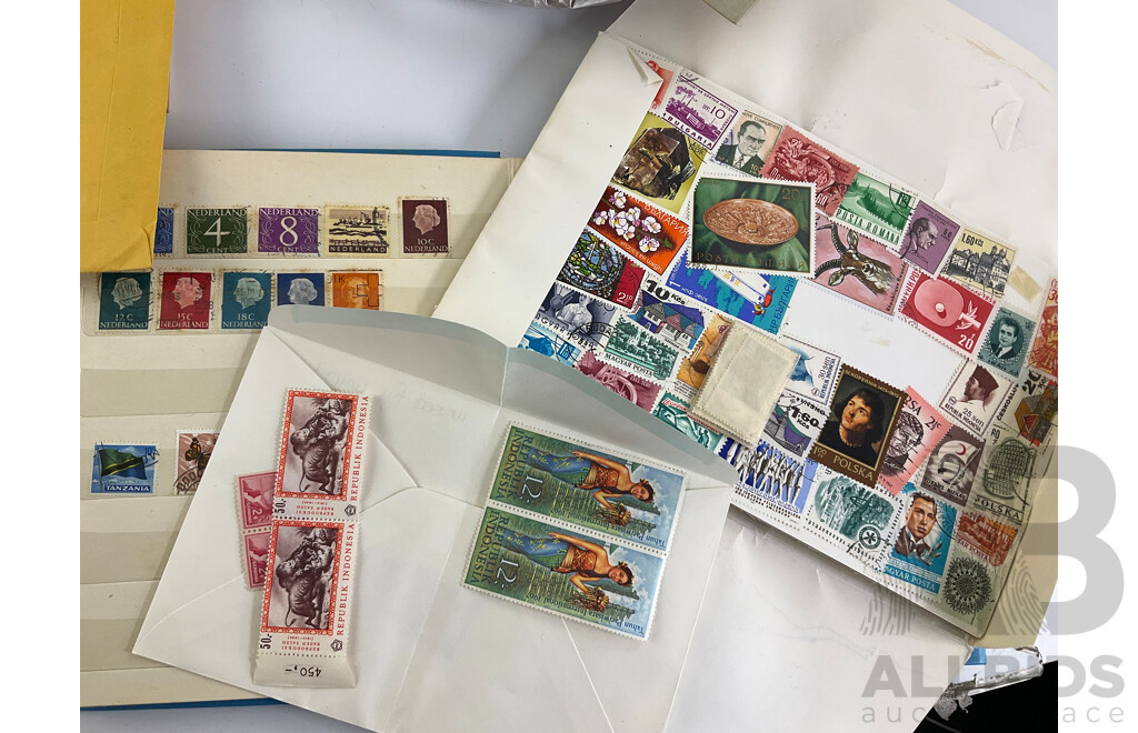Collection of International Philately Including British Mint 1986 Mint Stamp Collectors Pack, All Nations Stamp Album, The Globe Stamp Album, USA, Indonesia, Netherland, Australia, Mongolia, UK and More