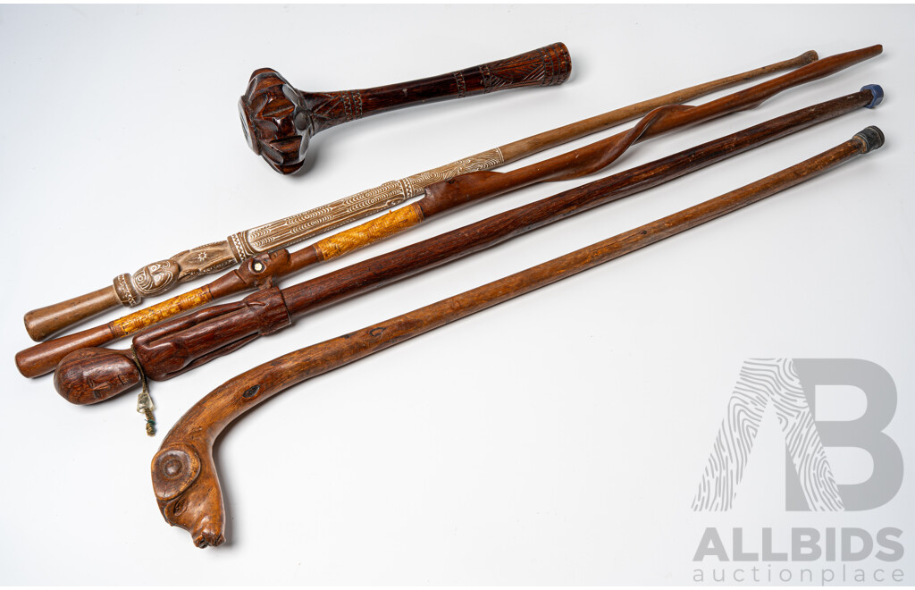 Collection Tribal Walking Staffs Including Two Massim Trobriand Island Examples, Dogs Head Example and Fijian Club