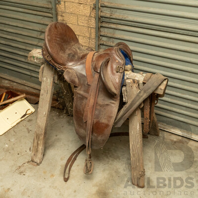 17" Unbranded Stock Saddle with Stirrups & Girth on Saw Horse
