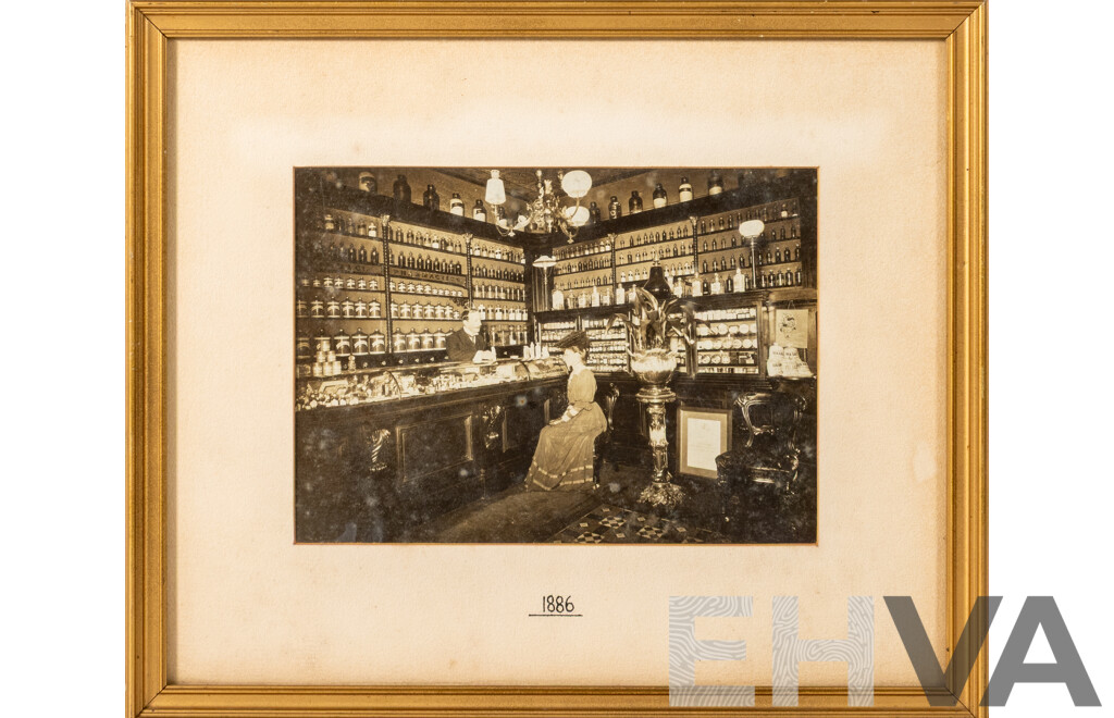 Artist Unknown, (1880s), Wonderful Antique Photograph of an Apothecary with Lady Seated & Man Behind Counter (1886), 28 x 33 cm (frame)