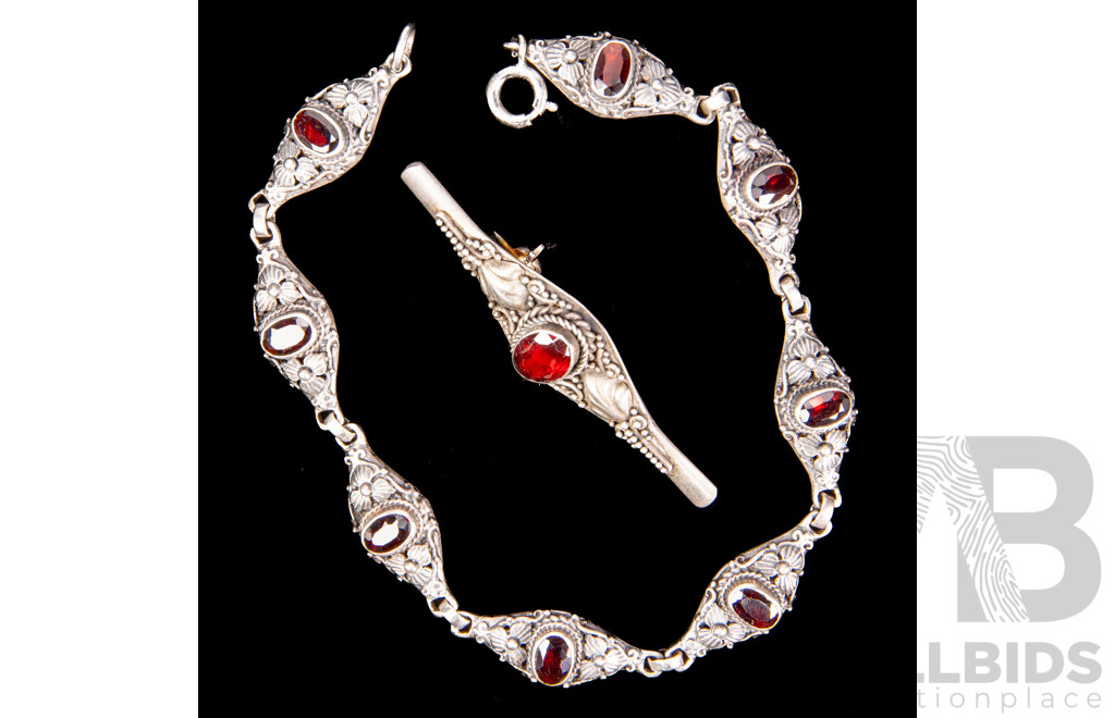 Sterling Silver Garnet Set Bracelet and Brooch Eight Link Bracelet with Floral Design, Each Link Set with Oval Garnet. Together with a Matching Bar Brooch.