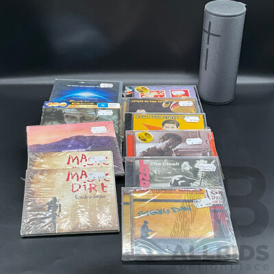 Assorted CDs/DVDs and Ultimate Ears Speaker