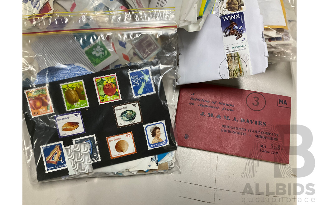 Collection of International Cancelled Stamps Including USA, New Zealand, Australia, UK, Germany, Malaysia, India, Romania, Italy and More - Approximately Two Kilograms